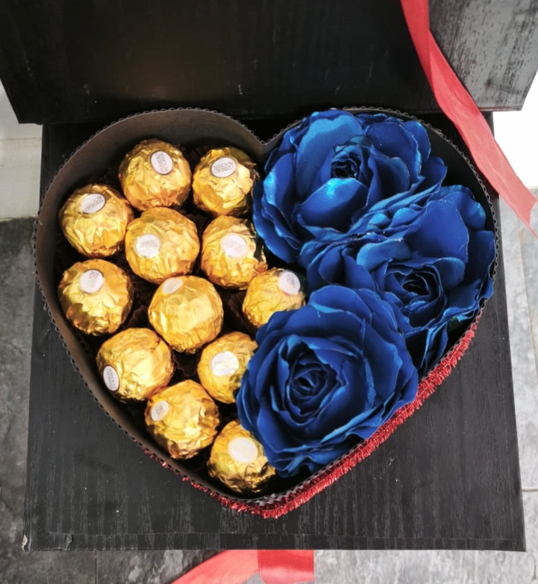 Caja de corazón con chocolates y rosas azules